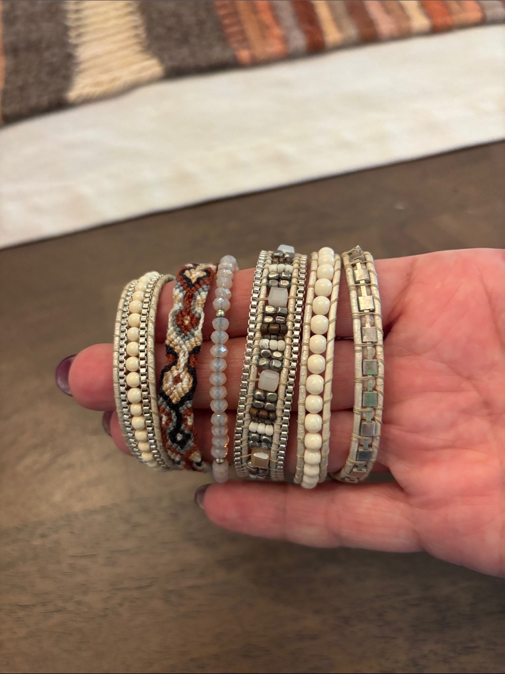 Stack of Women's White Beaded and Braided Bracelets